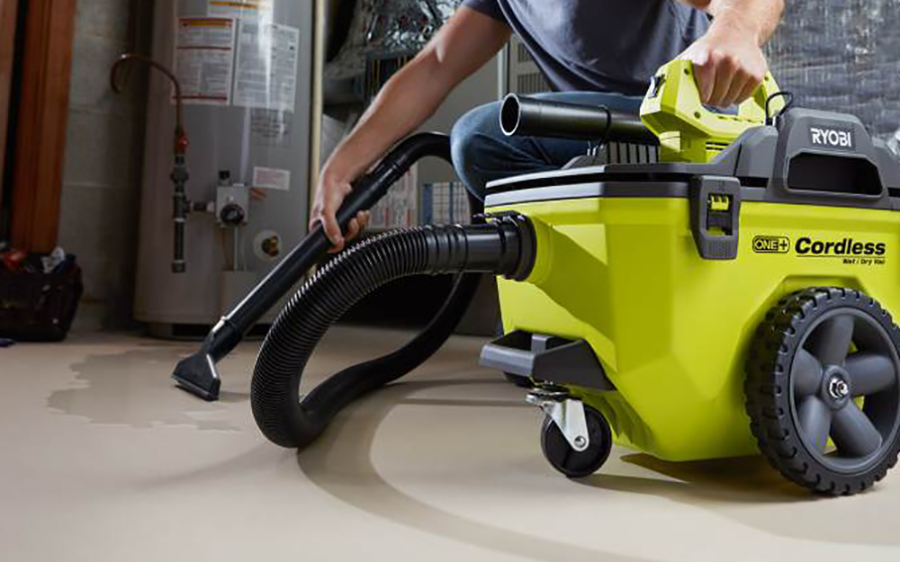 A person vacuuming a floor. A person vacuuming a floor.