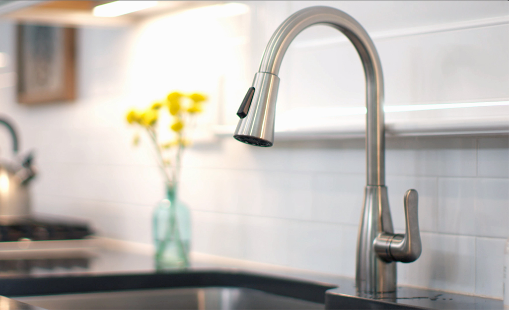 A kitchen sink featuring a faucet with a cartridge faucet.