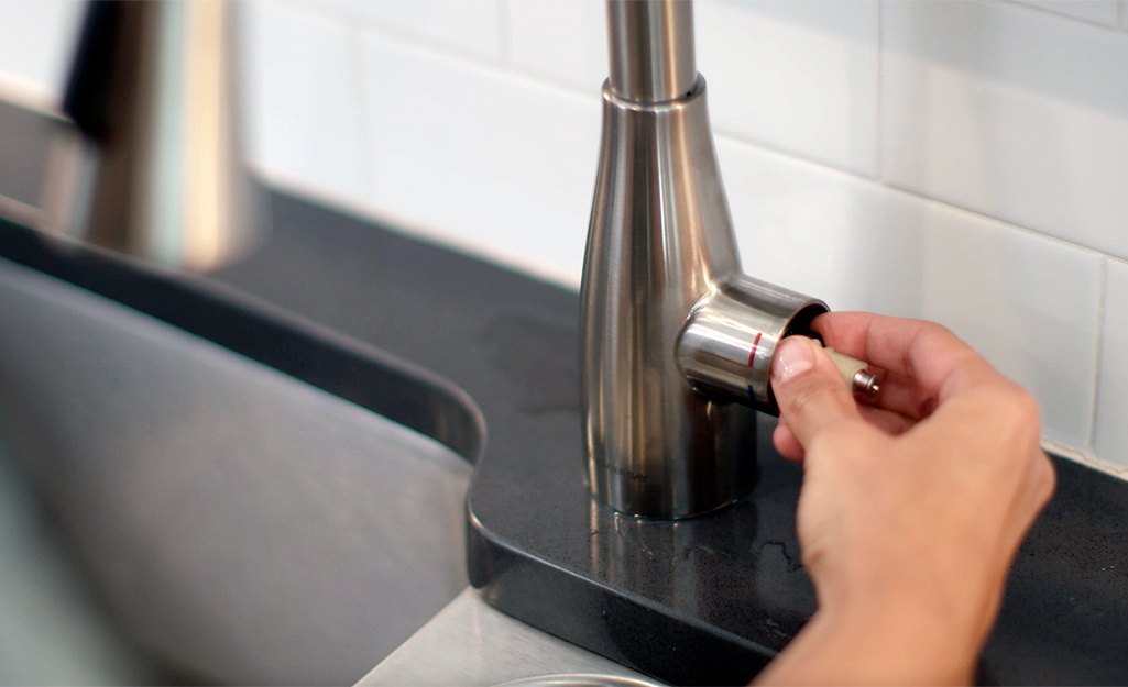 Someone replaces the cartridge in a cartridge faucet.