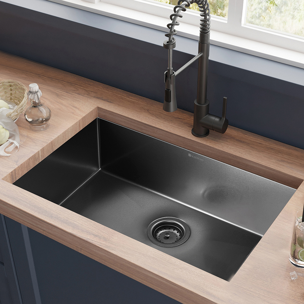 An undermount kitchen sink with black faucet.