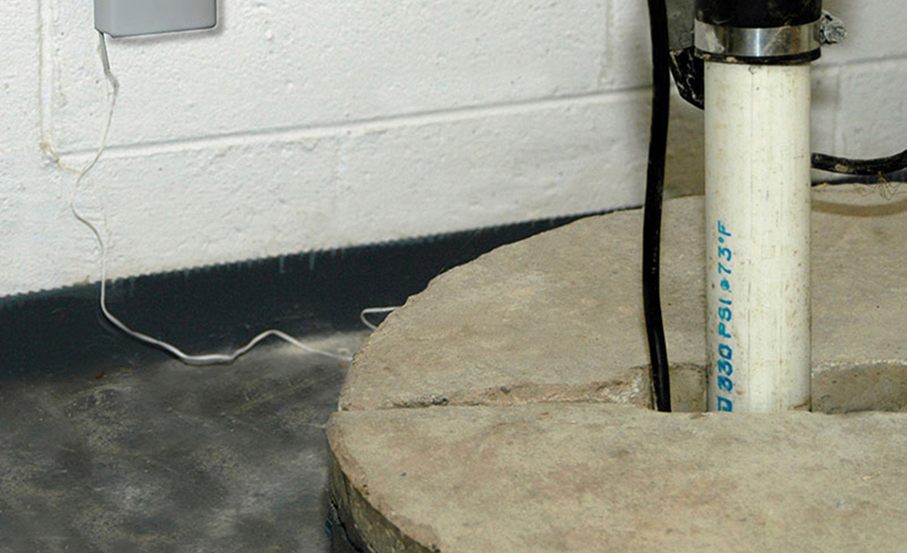 A concrete sump pit cover covers a sump water basin.