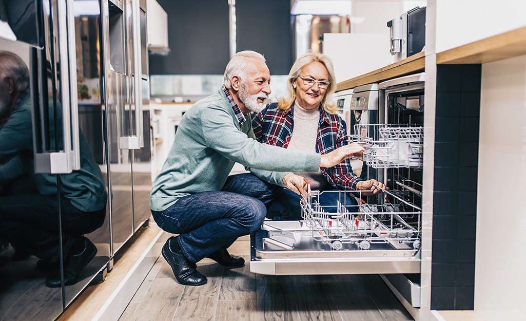 A couple shops for a new dishwasher at The Home Depot.