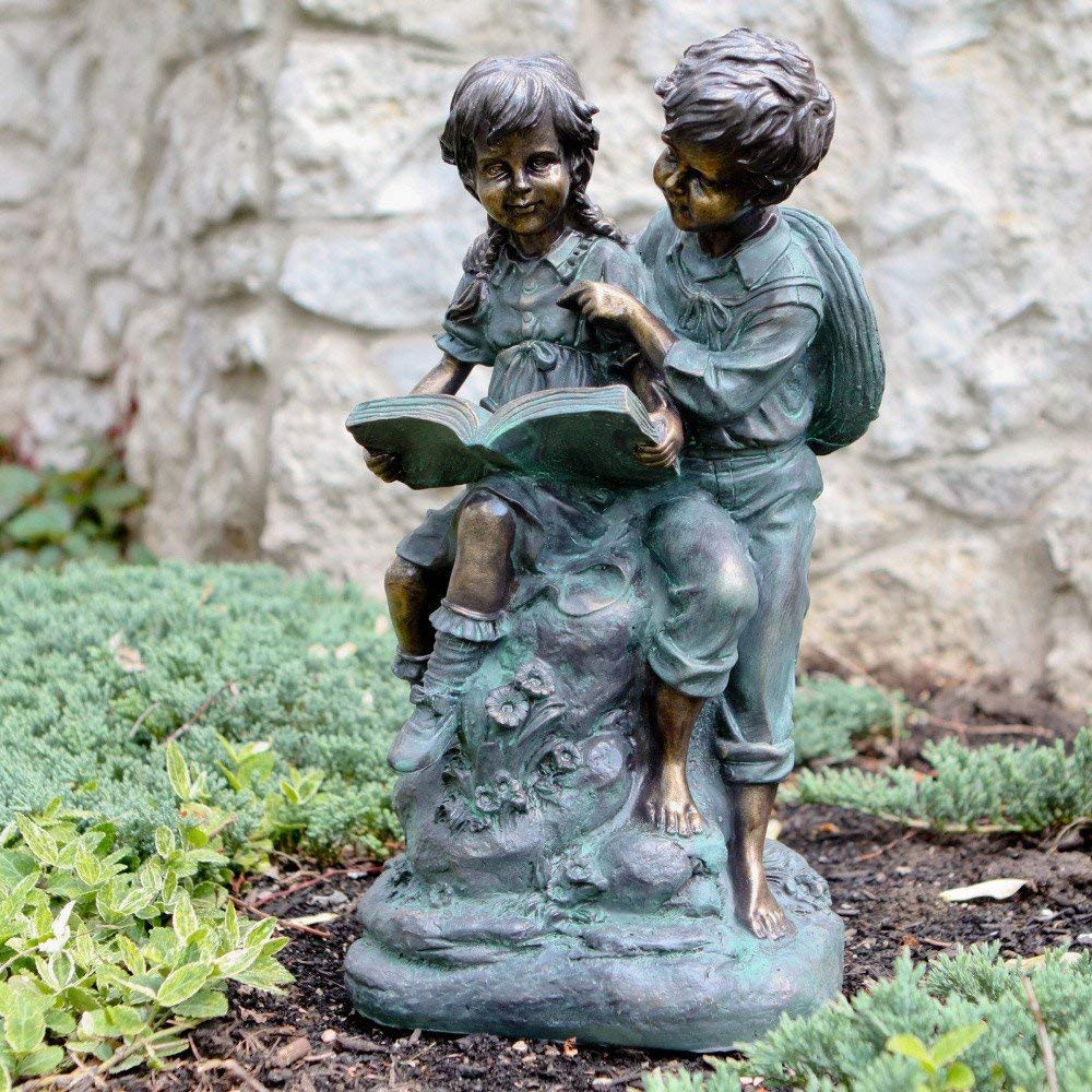 A statue of two kids reading.