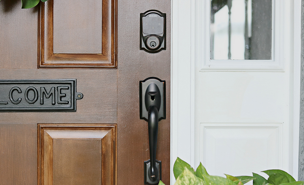 A deadbolt lock installed on a brown exterior door.