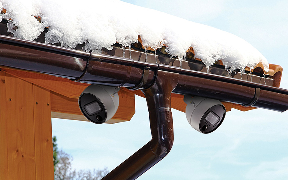 Security cameras are installed along a roofline of a home for exterior surveillance.