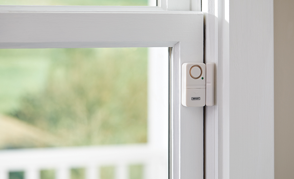 A window security home alarm sensor is installed on a window.
