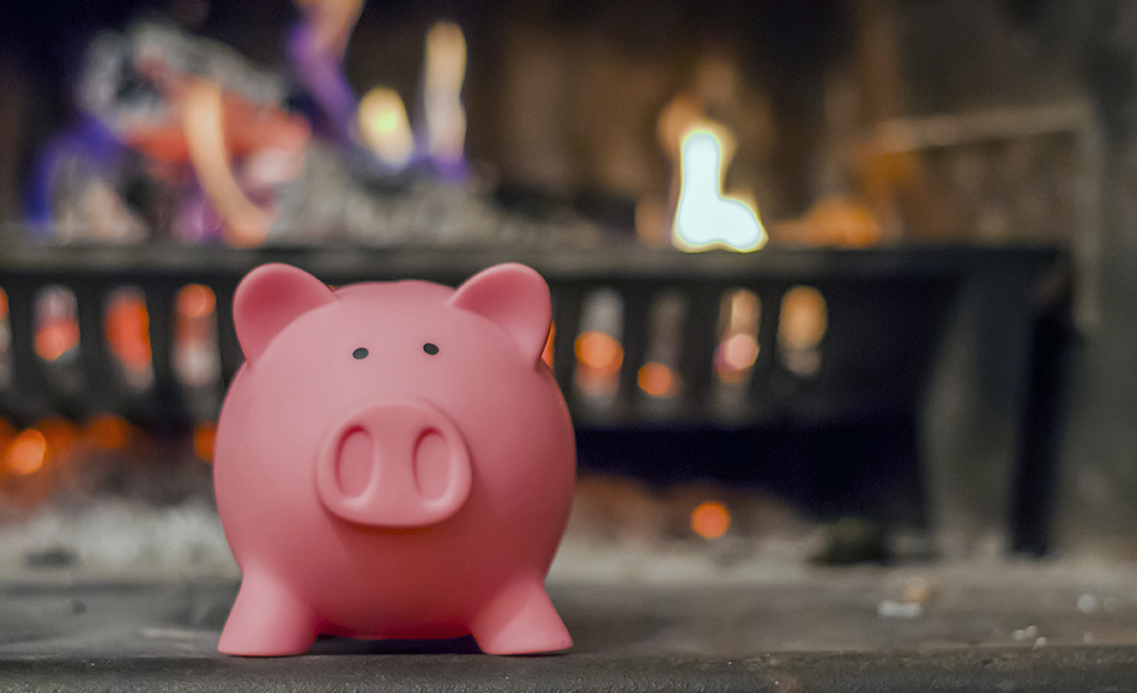 A piggybank in front of a fireplace.
