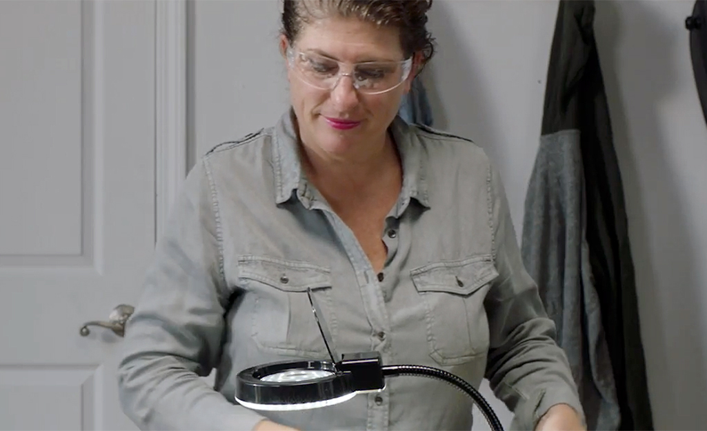 A person preparing to solder wears safety glasses.