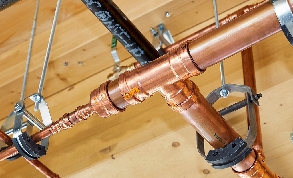 Copper pipes joined using press-connect fittings.