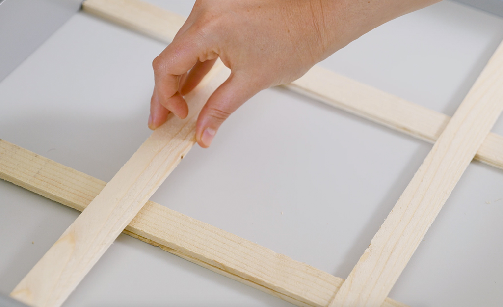 A person arranges shims in a drawer before cutting. 