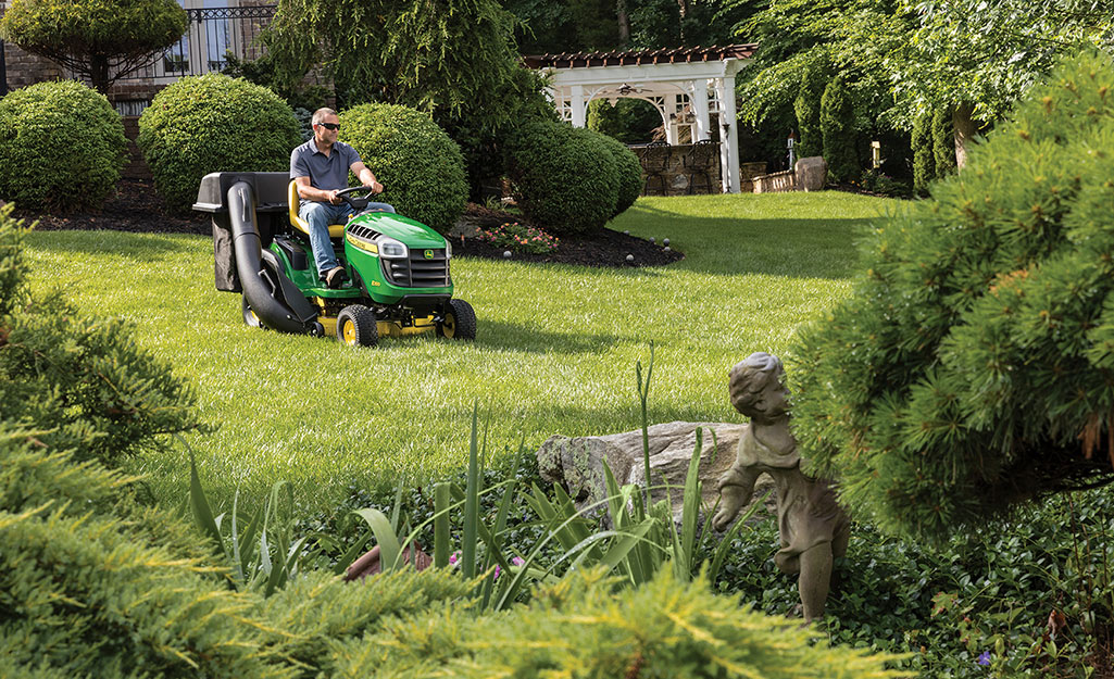 A man mows a nice green lawn.