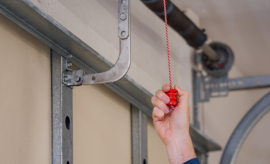 A person pulls the emergency release of a garage door.