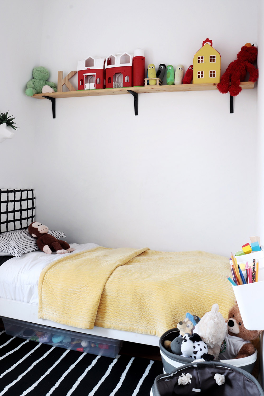 A kid's bedroom set with toys on a shelf