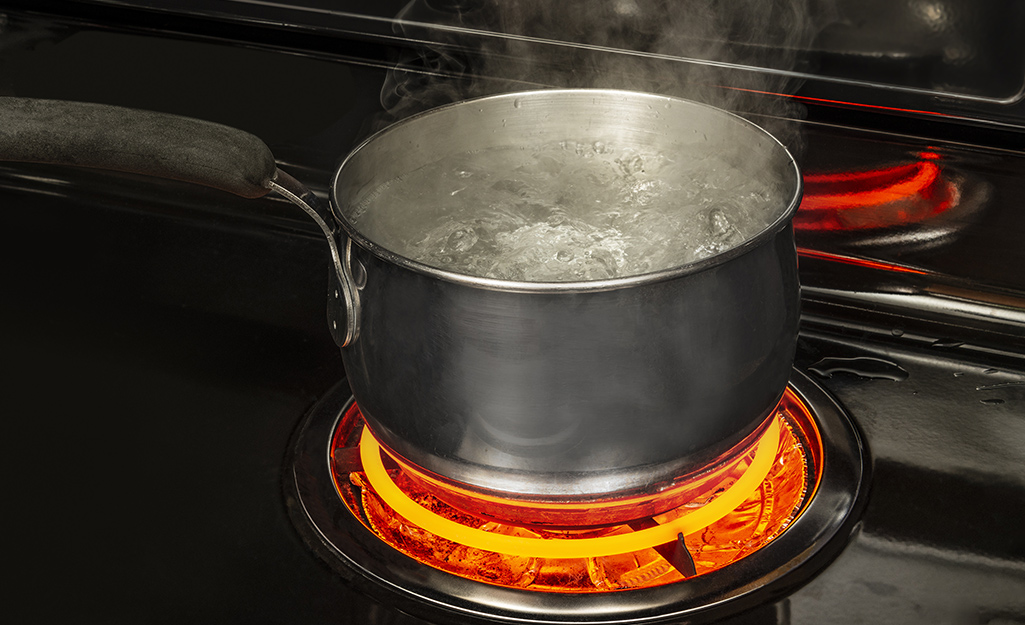 A pot of boiling water on a stove.