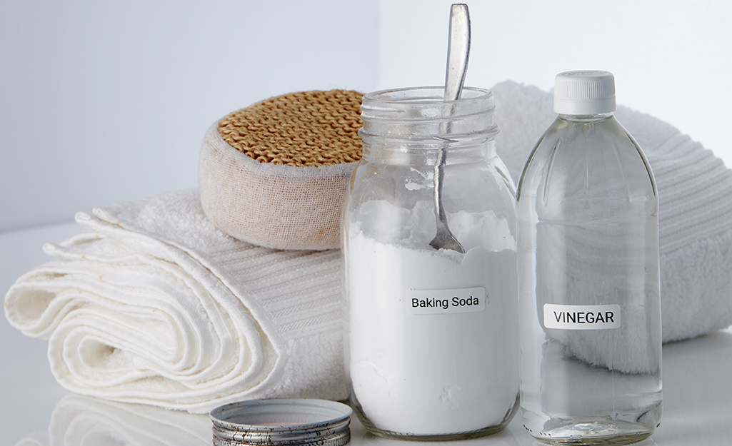 A jar of baking soda and bottle of vinegar.