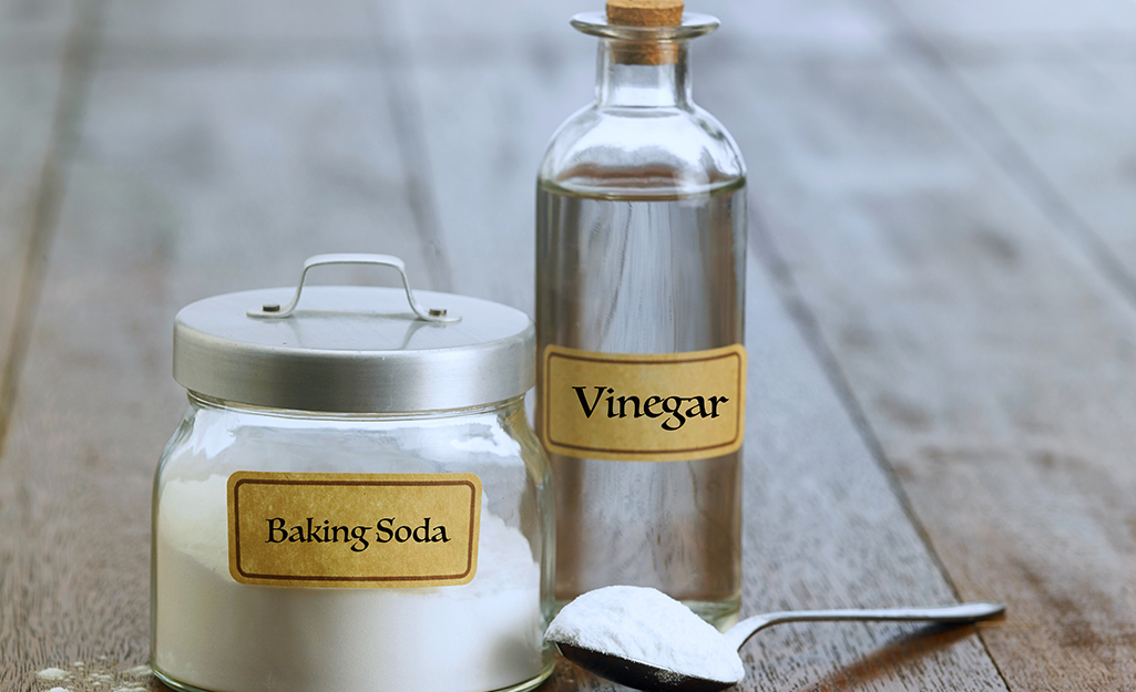 baking soda and vinegar on a wooden surface