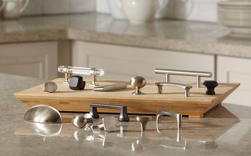 A sample board of drawer pulls, handles and hardware for kitchen cabinets.