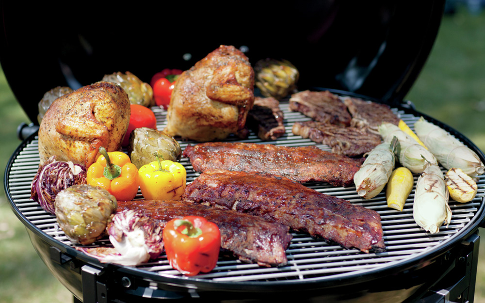 Food is grilled on a charcoal grill. 