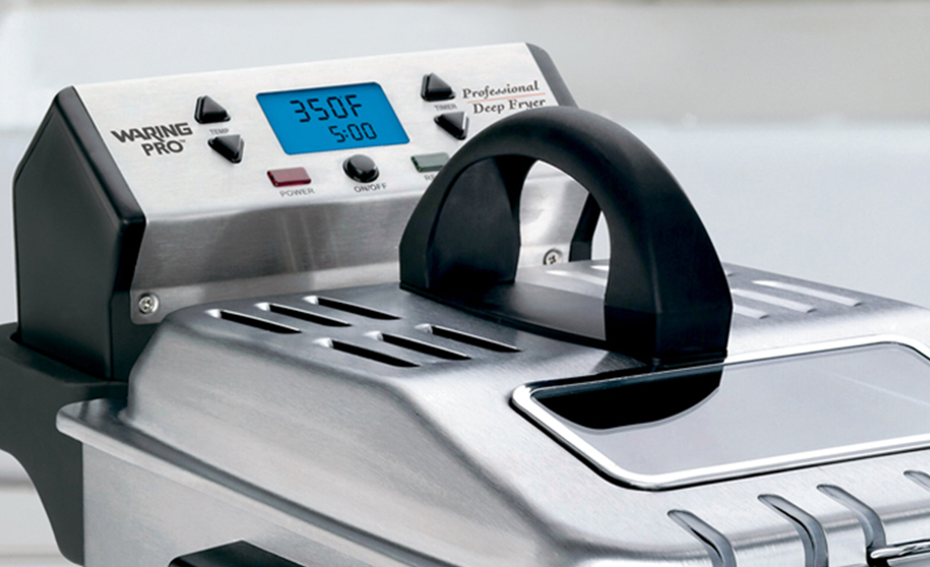 A deep fryer with a digital temperature display on the control panel. A deep fryer with a digital temperature display on the control panel.