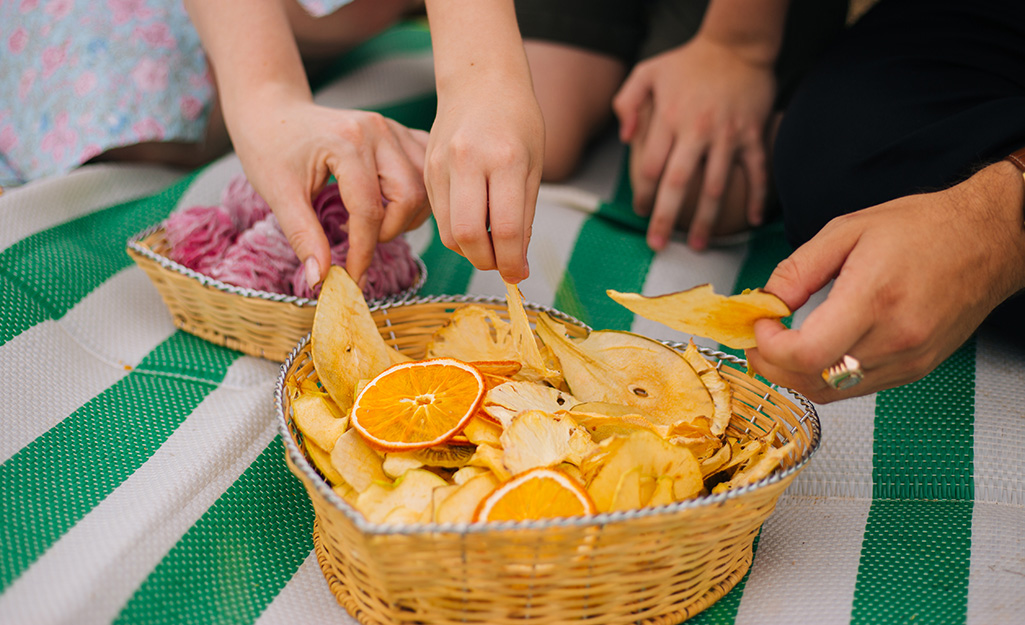 Family enjoying dried orange slices, apply rings and other fruit snacks.