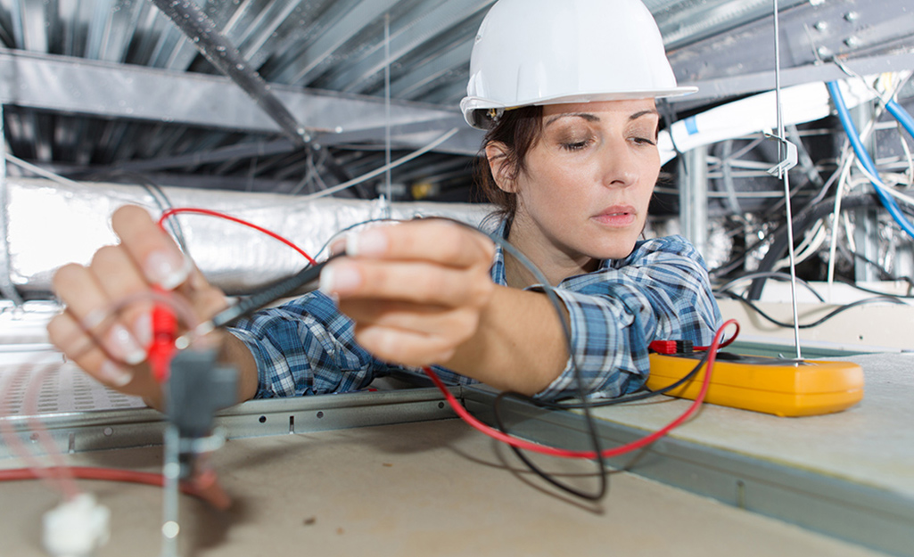 Someone using a multimeter on a job site.