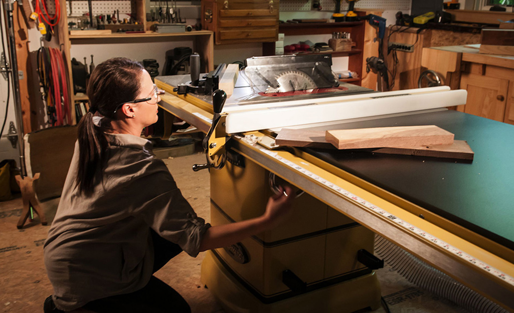 A person using a stationary table saw.