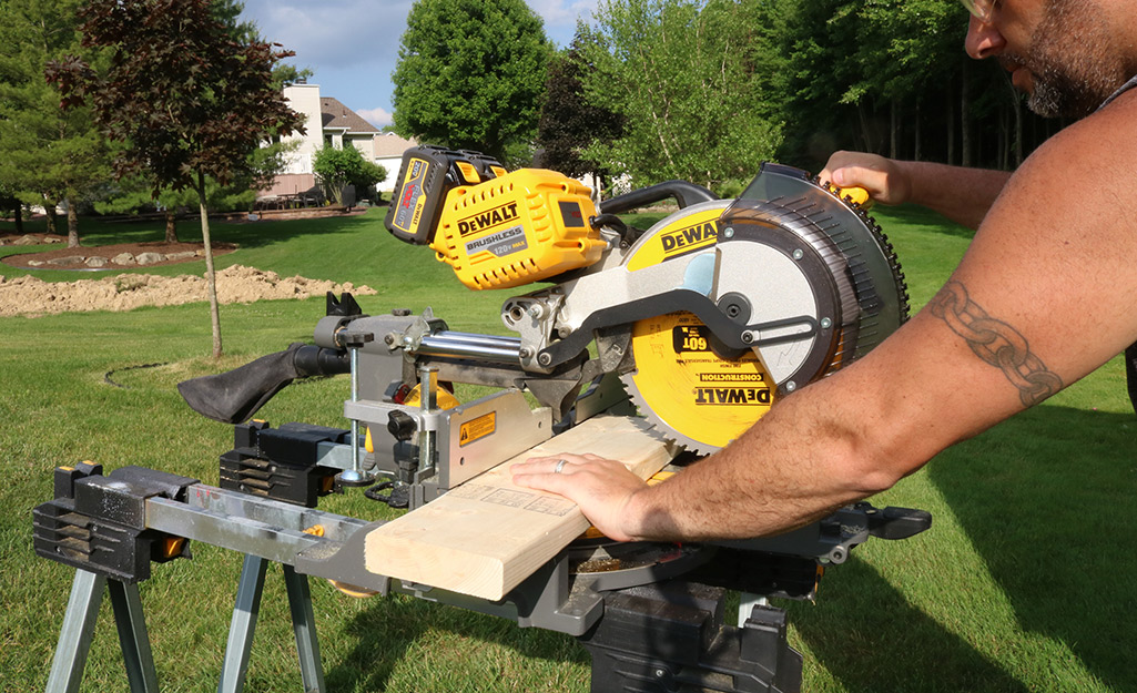 A person using a table saw at a job site.