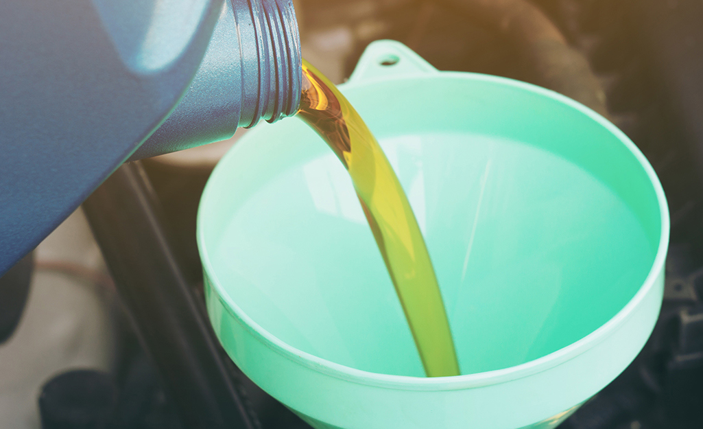 Oil being poured into a funnel.