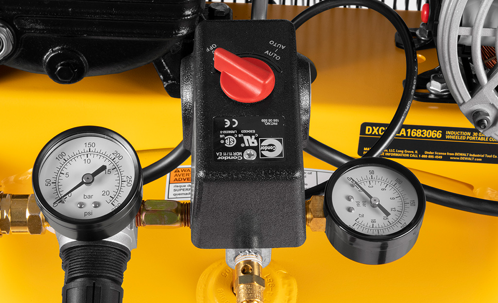 A closeup of the pressure gauges on an air compressor.