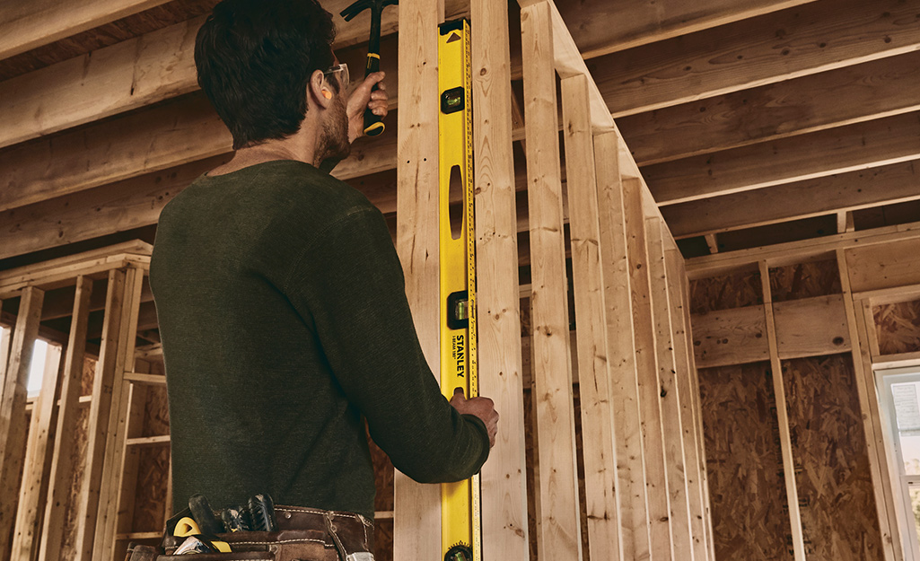 A person using a carpenter's level.