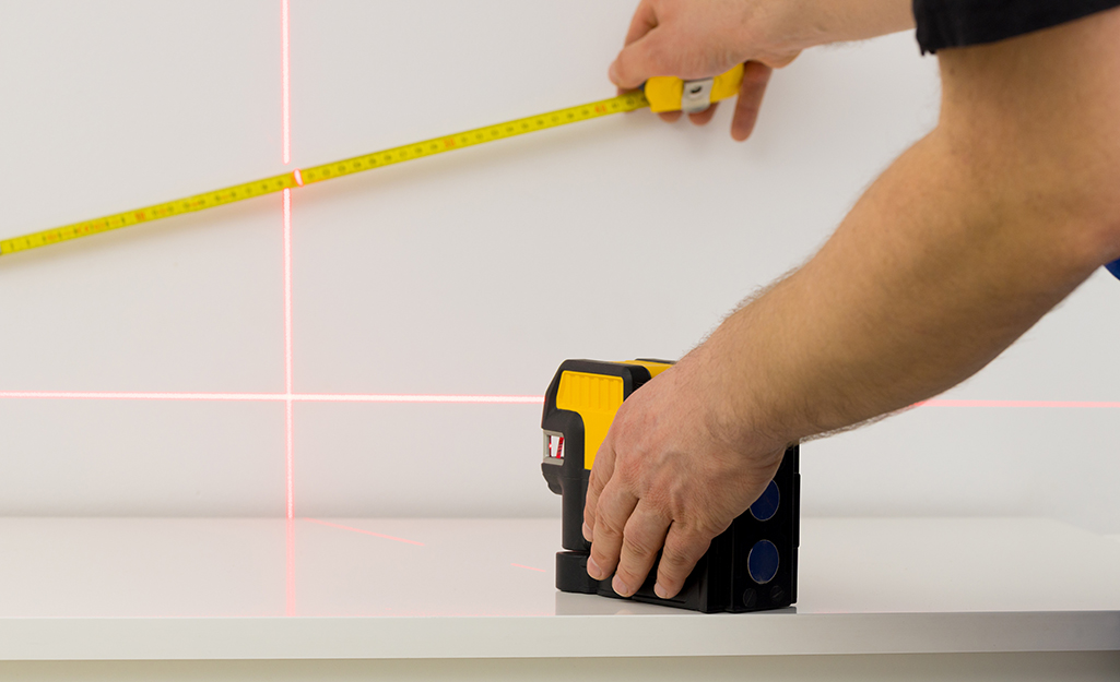 Person using laser guided level.