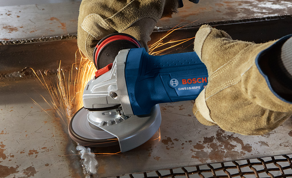 A weld being ground with an angle grinder. A weld being ground with an angle grinder.