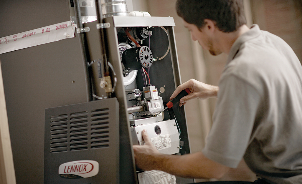 Man inspecting a furnace.