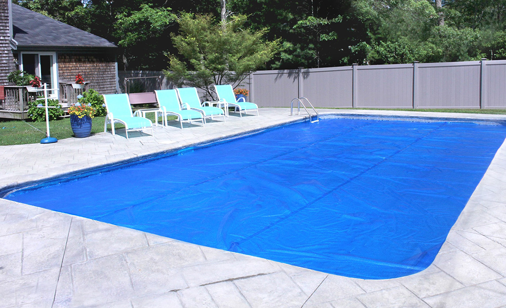 A pool cover over an in-ground pool.