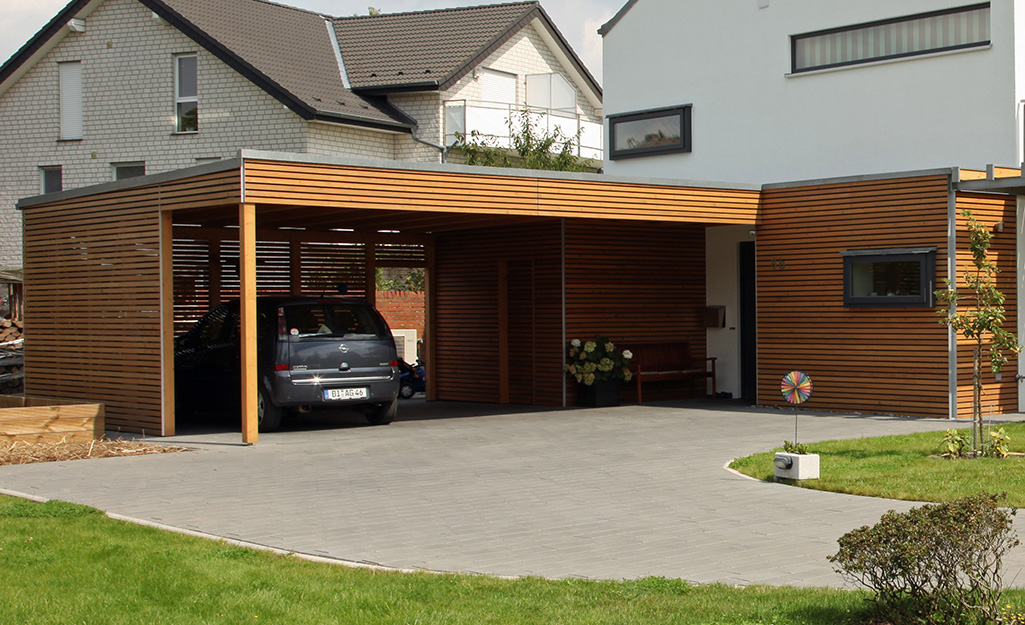 A car is parked underneath a carport.