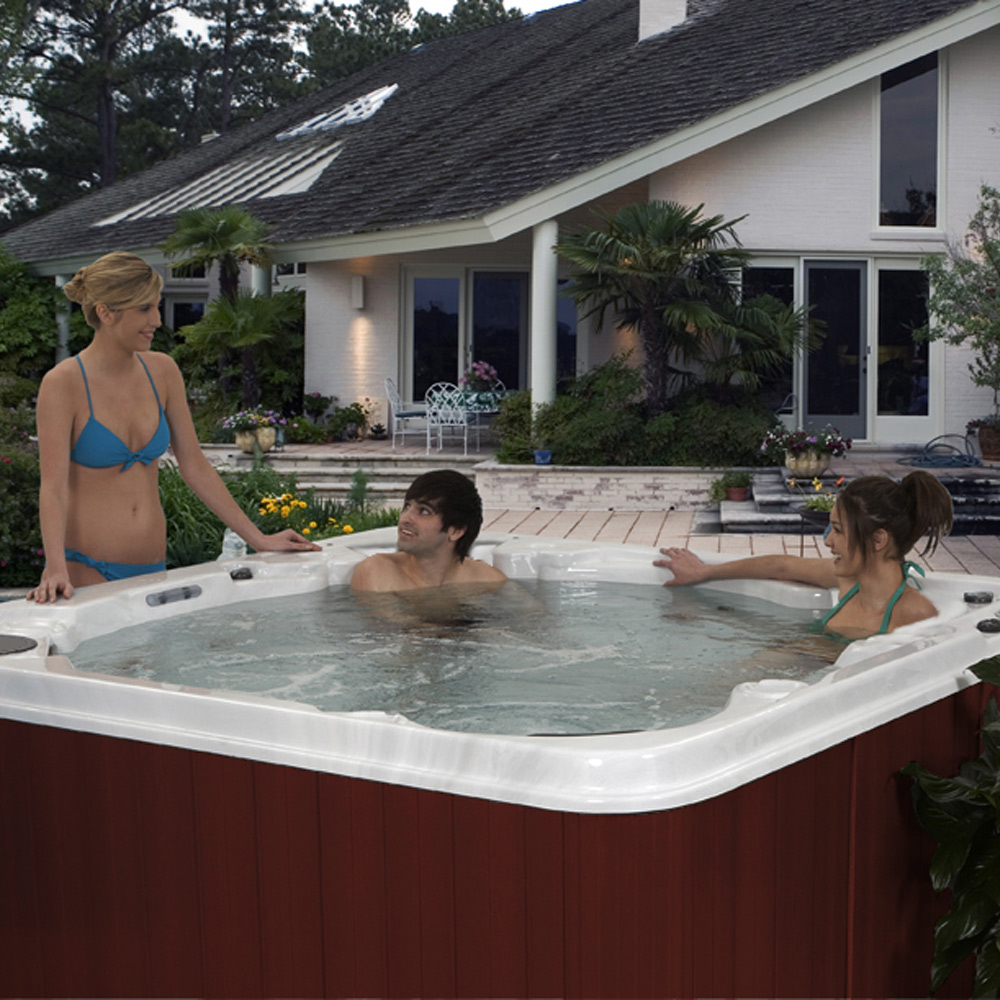 A bubbling hot tub sits on a patio.