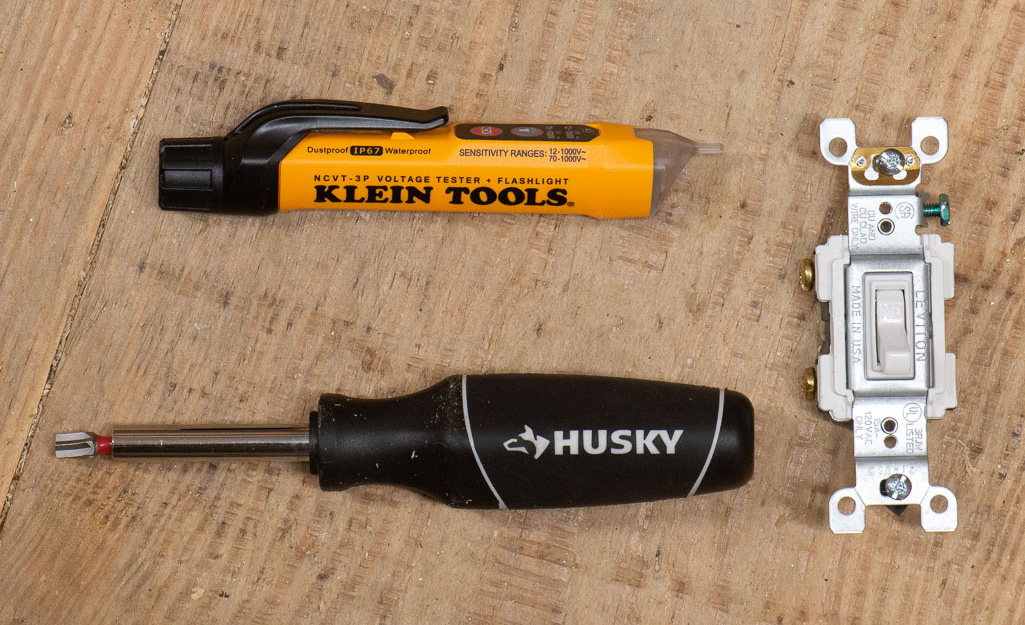 A non-contact voltage tester, screwdriver with an ec-1 bit, and a new light switch.