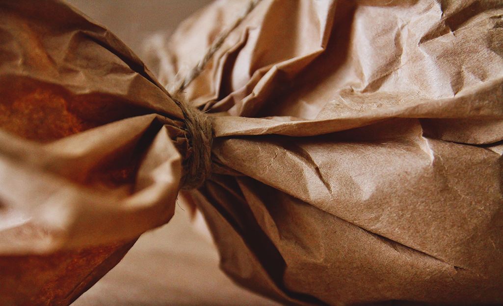 Brown paper wrapped around a gift and tied with string.
