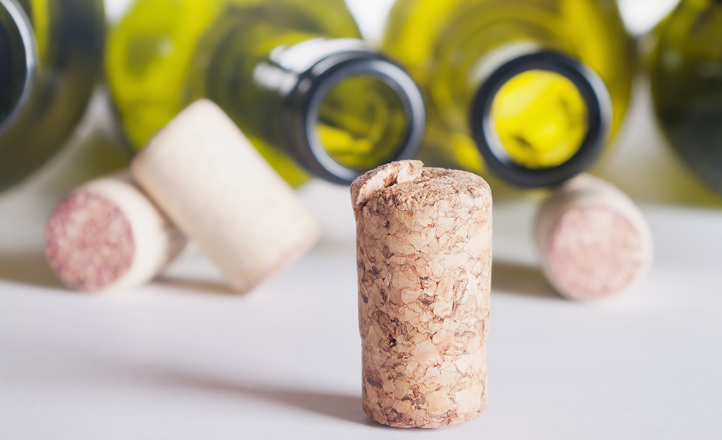 Clean, empty wine bottles and corks arranged on a table.