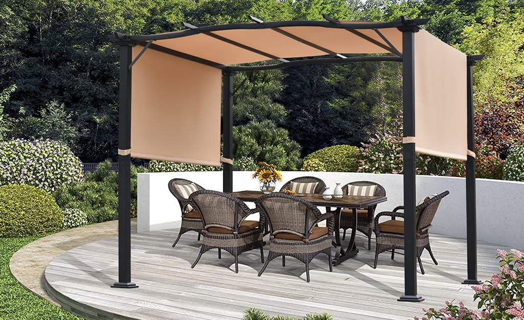 A canopy over a pergola shades an outdoor dining set with six chairs.