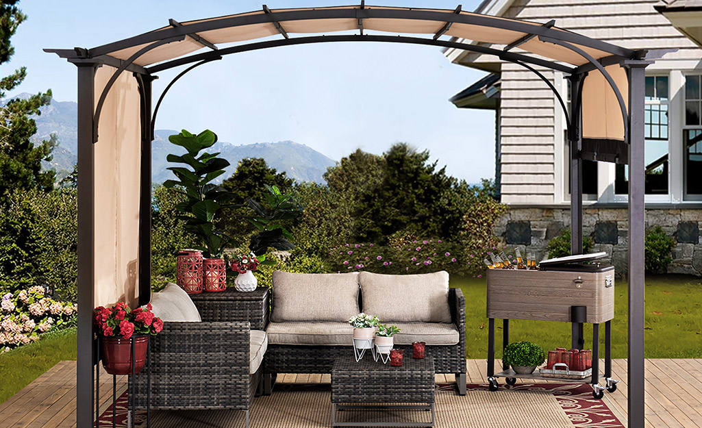 A pergola with adjustable shade canopy stands above a patio conversation set.