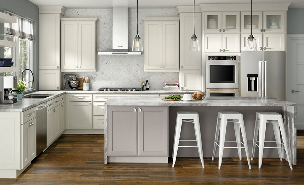 A kitchen island with seating space and three stools.