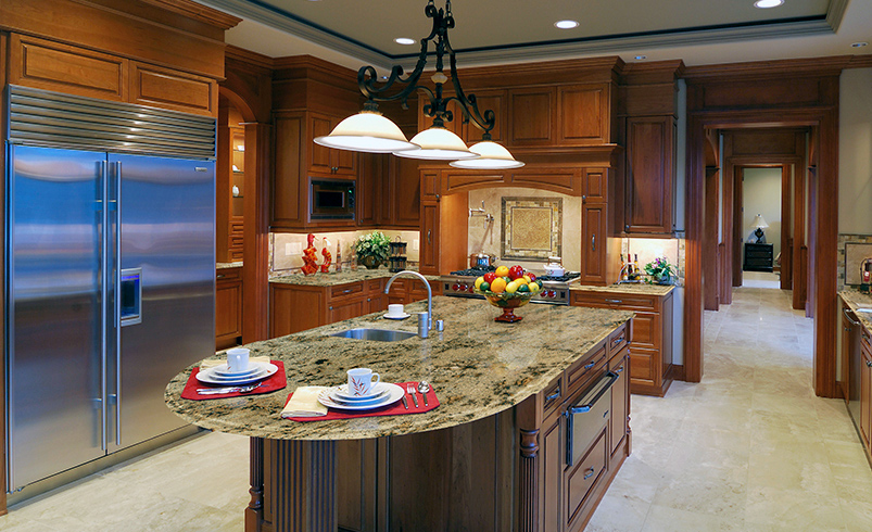 A kitchen island with a round edge and table attached