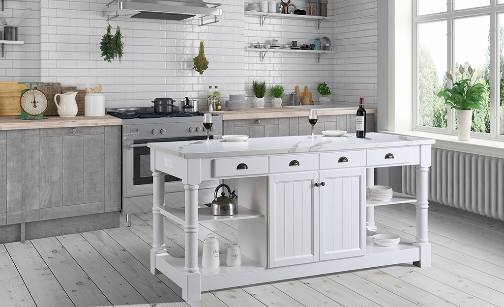 A white kitchen island with shelves, drawers and cabinets.