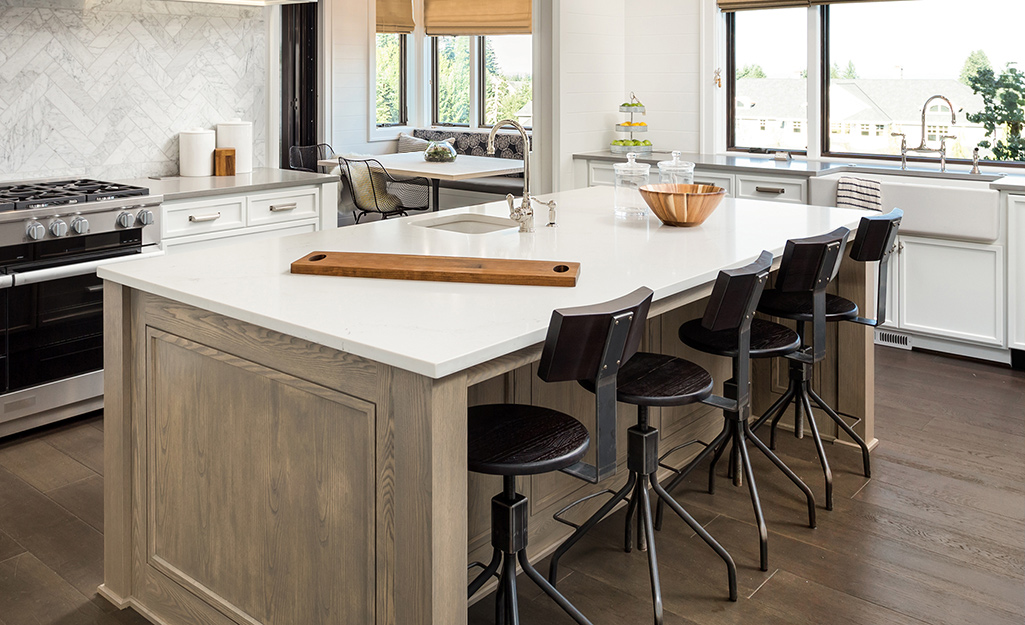 A country-style kitchen island with four stools.