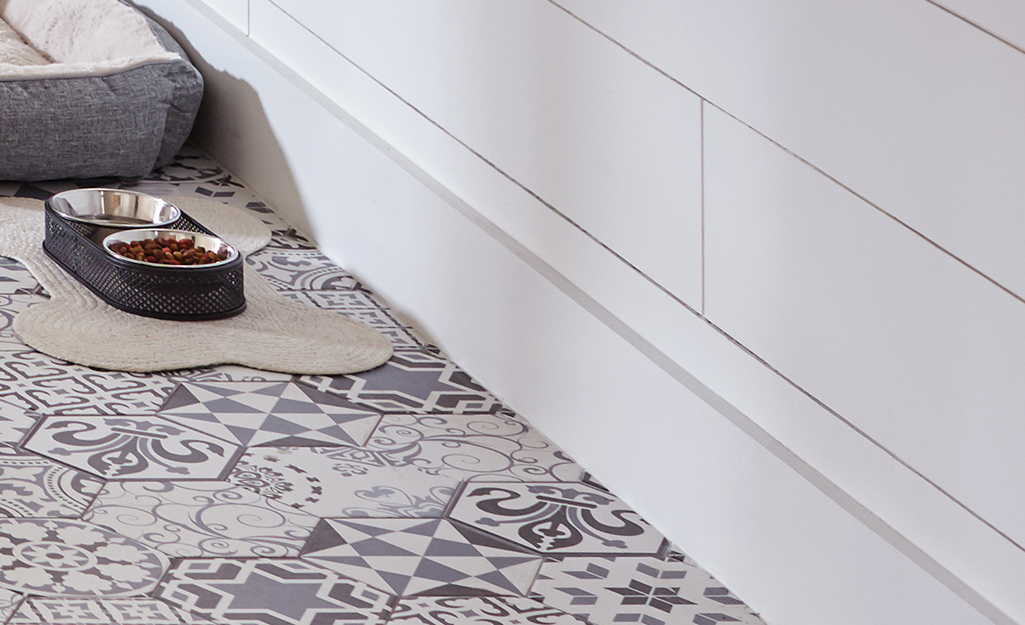 Dog bowl resting on finished tile floor.