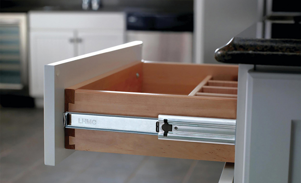 An open kitchen drawer installed with soft-close slides.