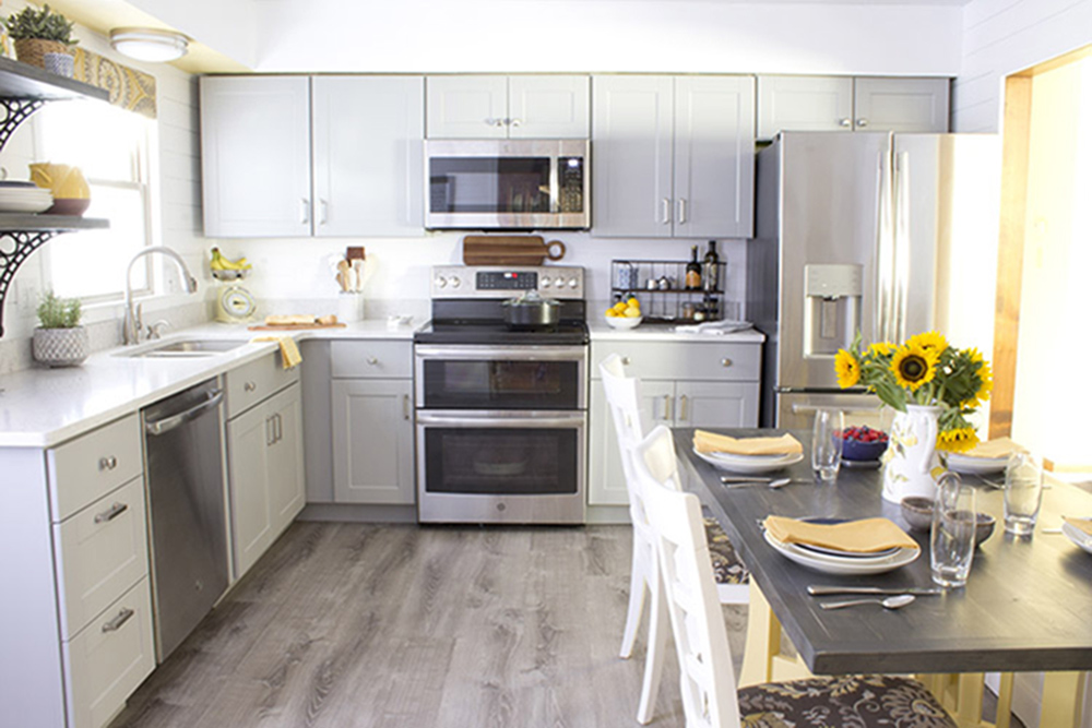 An updated kitchen with new cabinets, countertops, floors, and GE appliances.