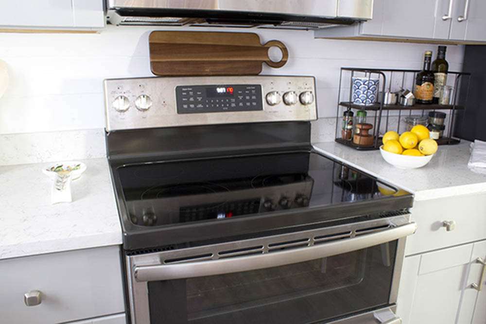 A GE stainless steel electric range and double oven.