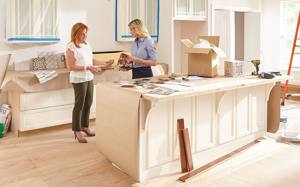 Two women consulting the remodel process in a kitchen